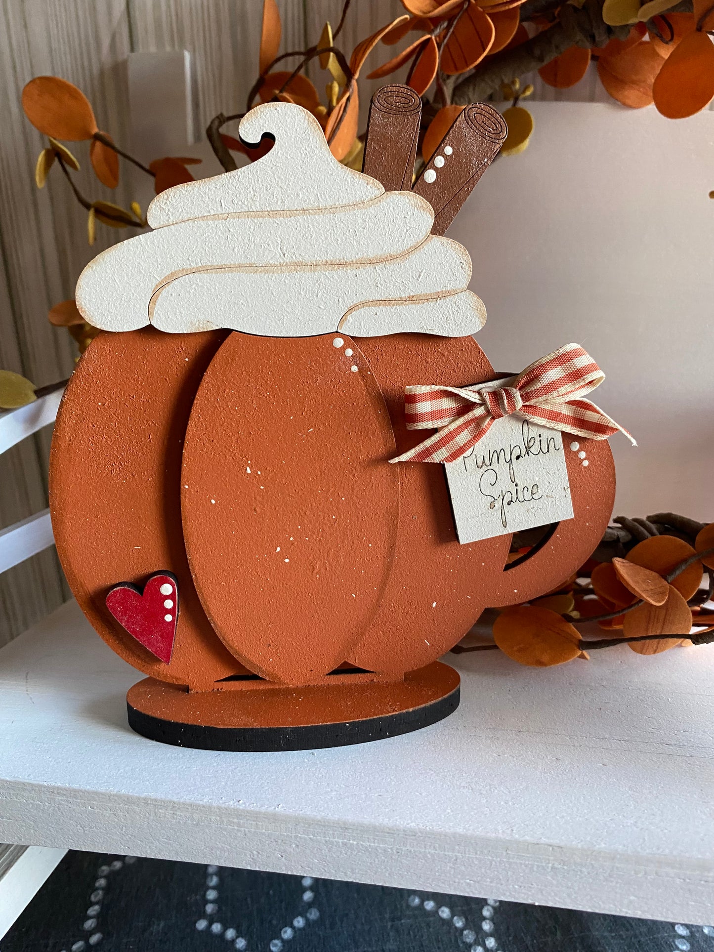 3D decorative pumpkin spice themed item with white top and a brown base, adorned with a bow and a tag that reads 'Pumpkin Spice'.