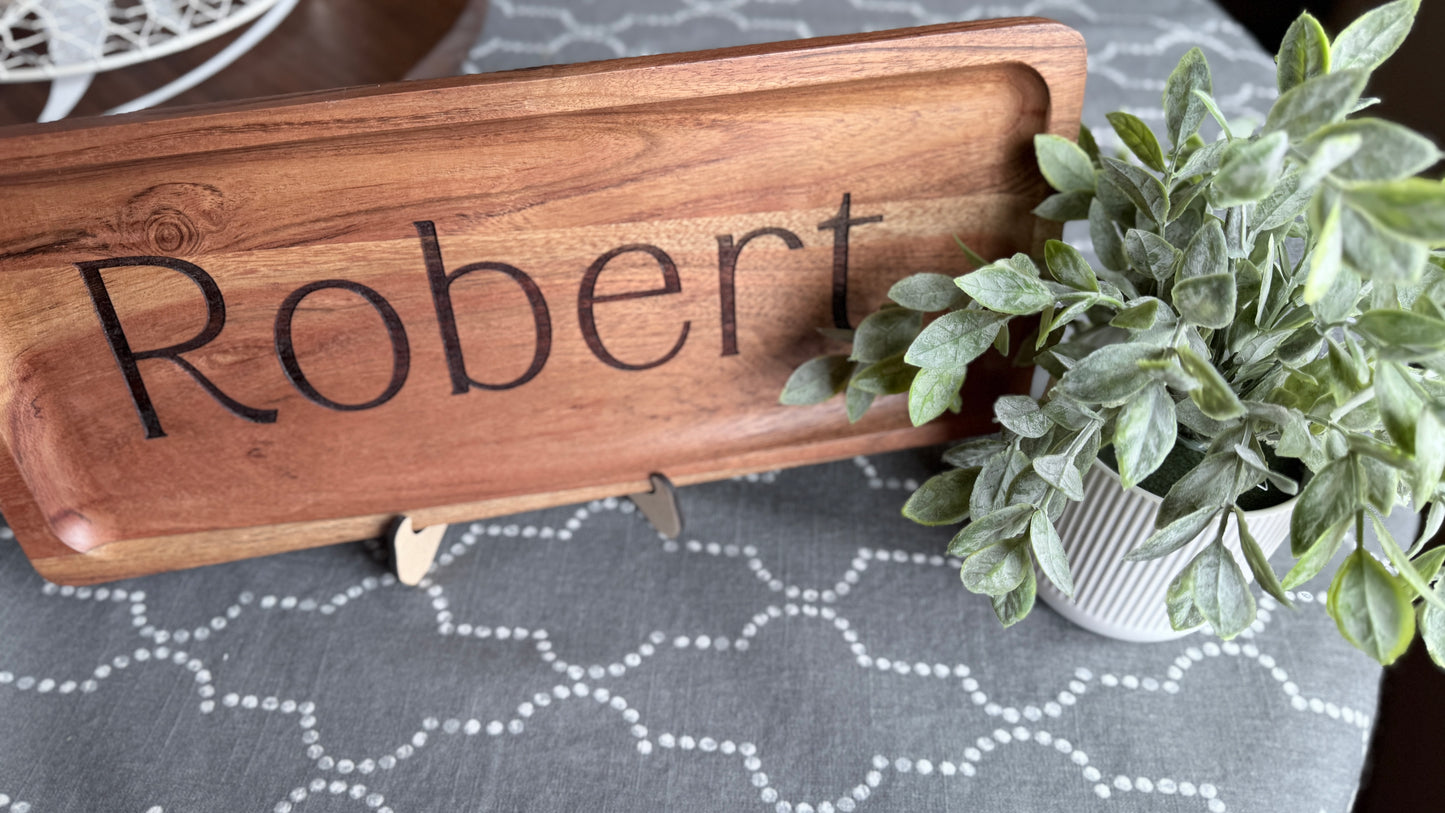 Engraved wood acacia tray with name Robert Engraved in center placed on easel