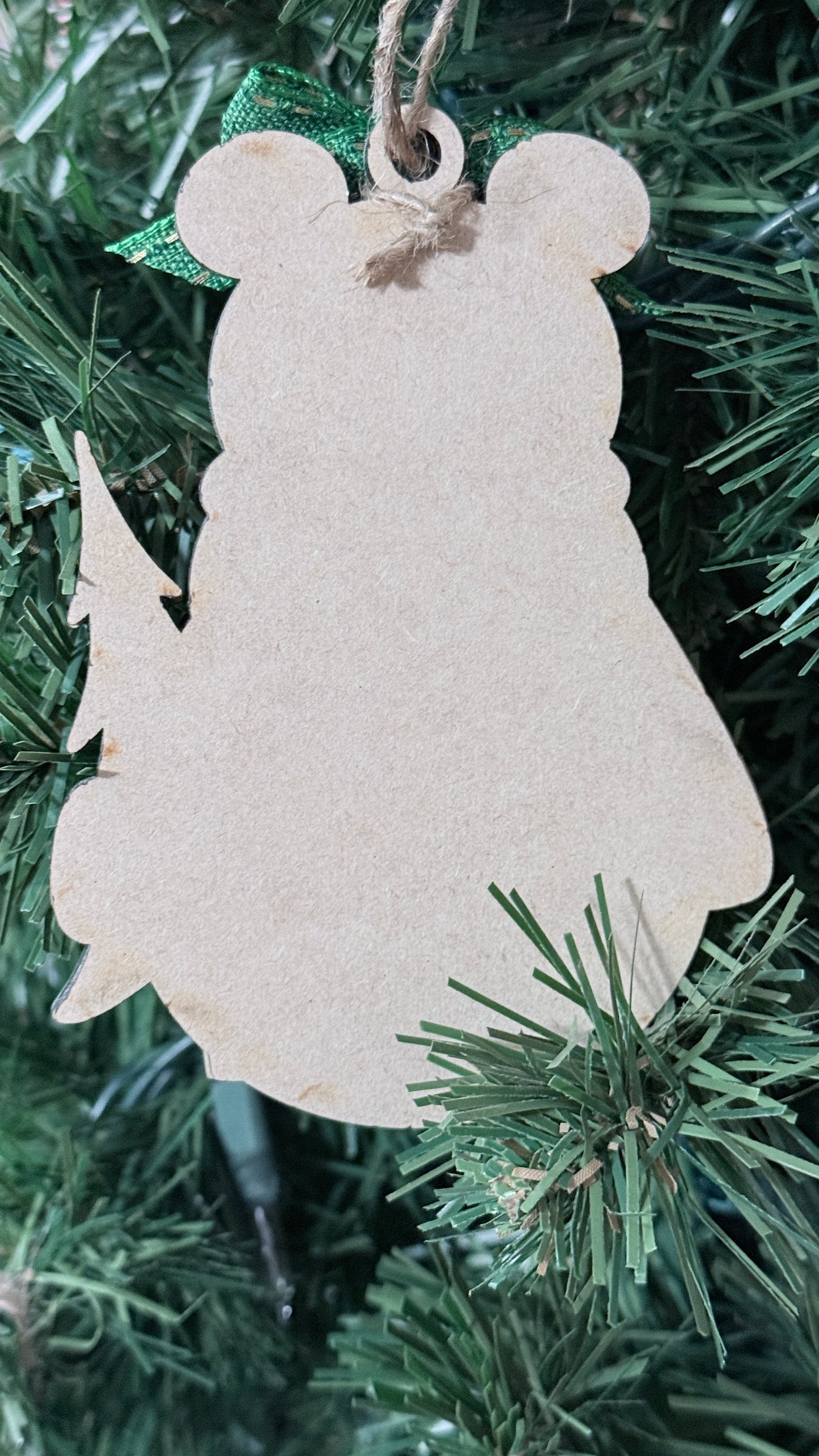 Back silhouette of bear ornament hung on a Christmas tree