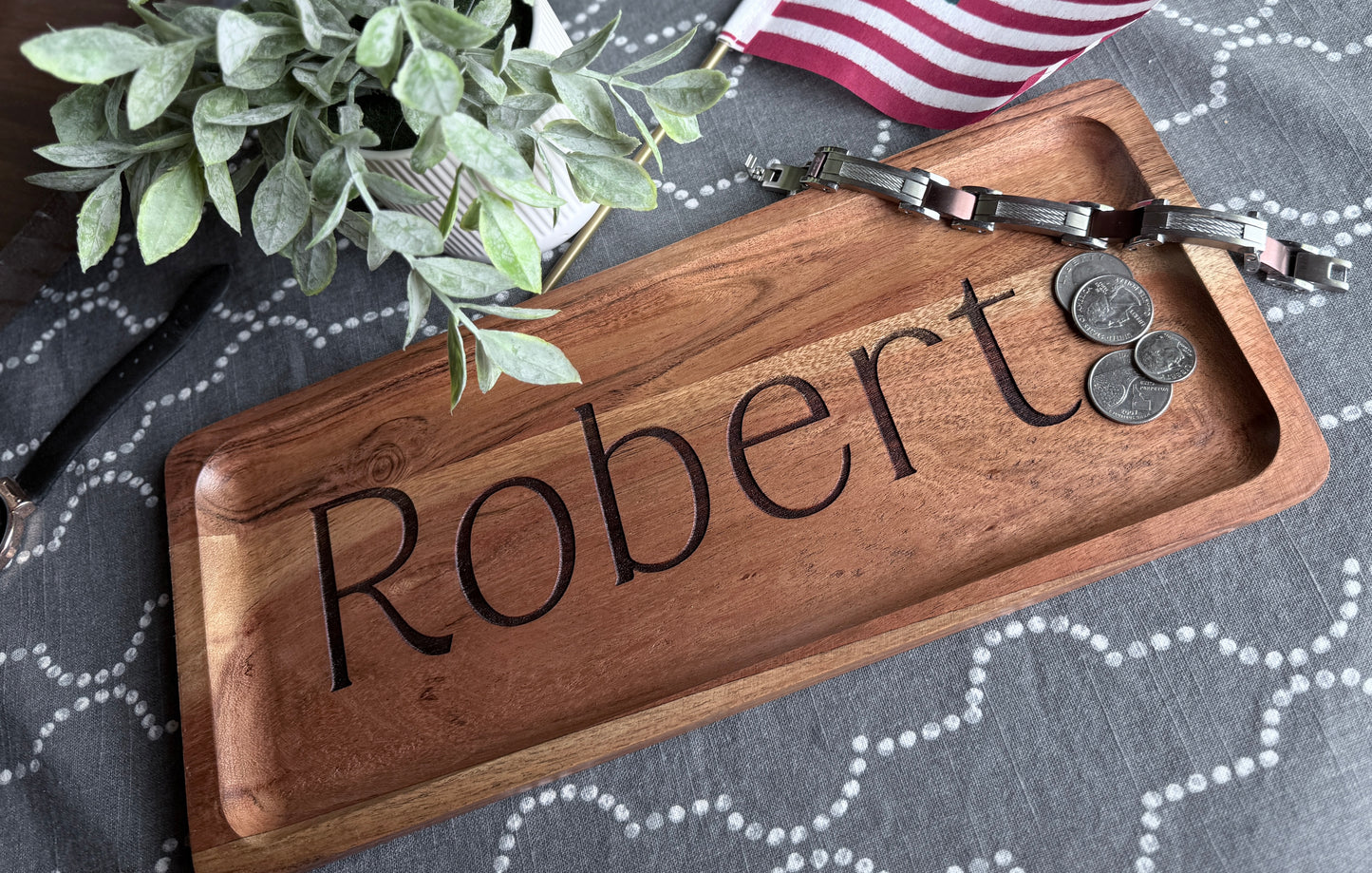 Robert engraved wood tray staged with plant to bring out wood tones