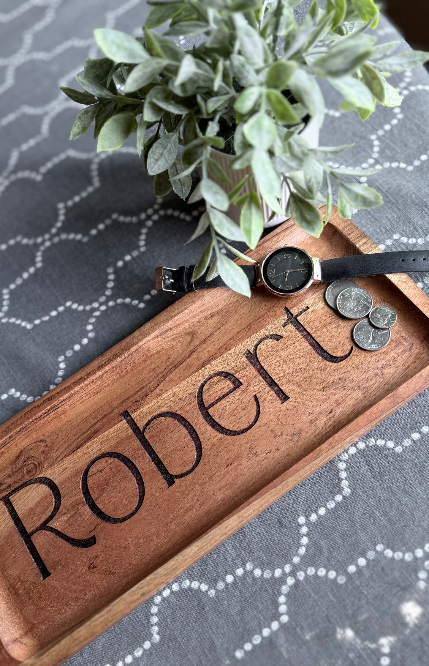 Engraved acacia wood tray staged with plant and coins for Robert