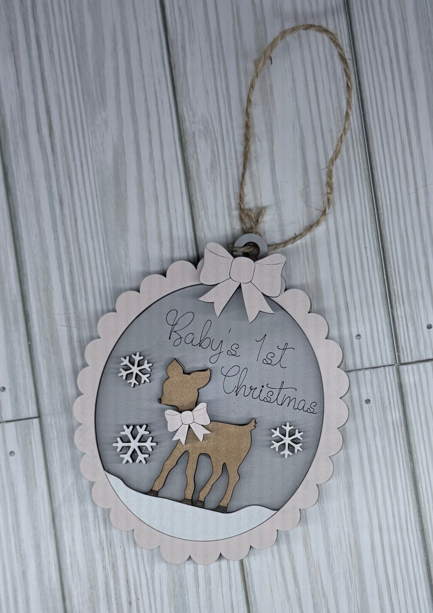 Decorative Christmas tag with a deer illustration and text on a wooden surface