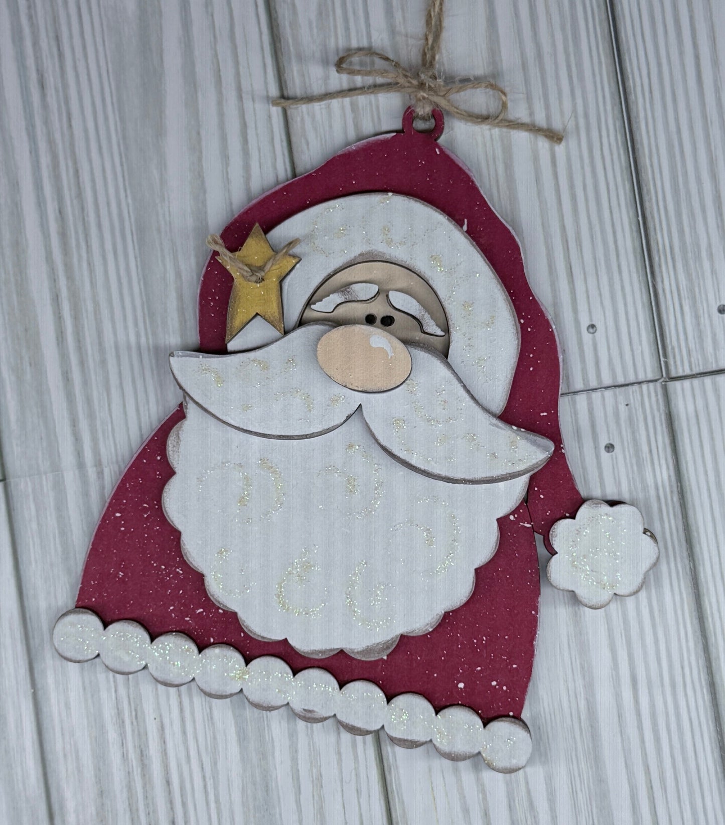 Decorative Santa Claus ornament hanging on a wooden surface