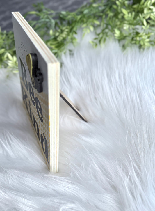 "Side angle view of Bee Kind wooden sign showing 3D raised bee detail and box sign depth"