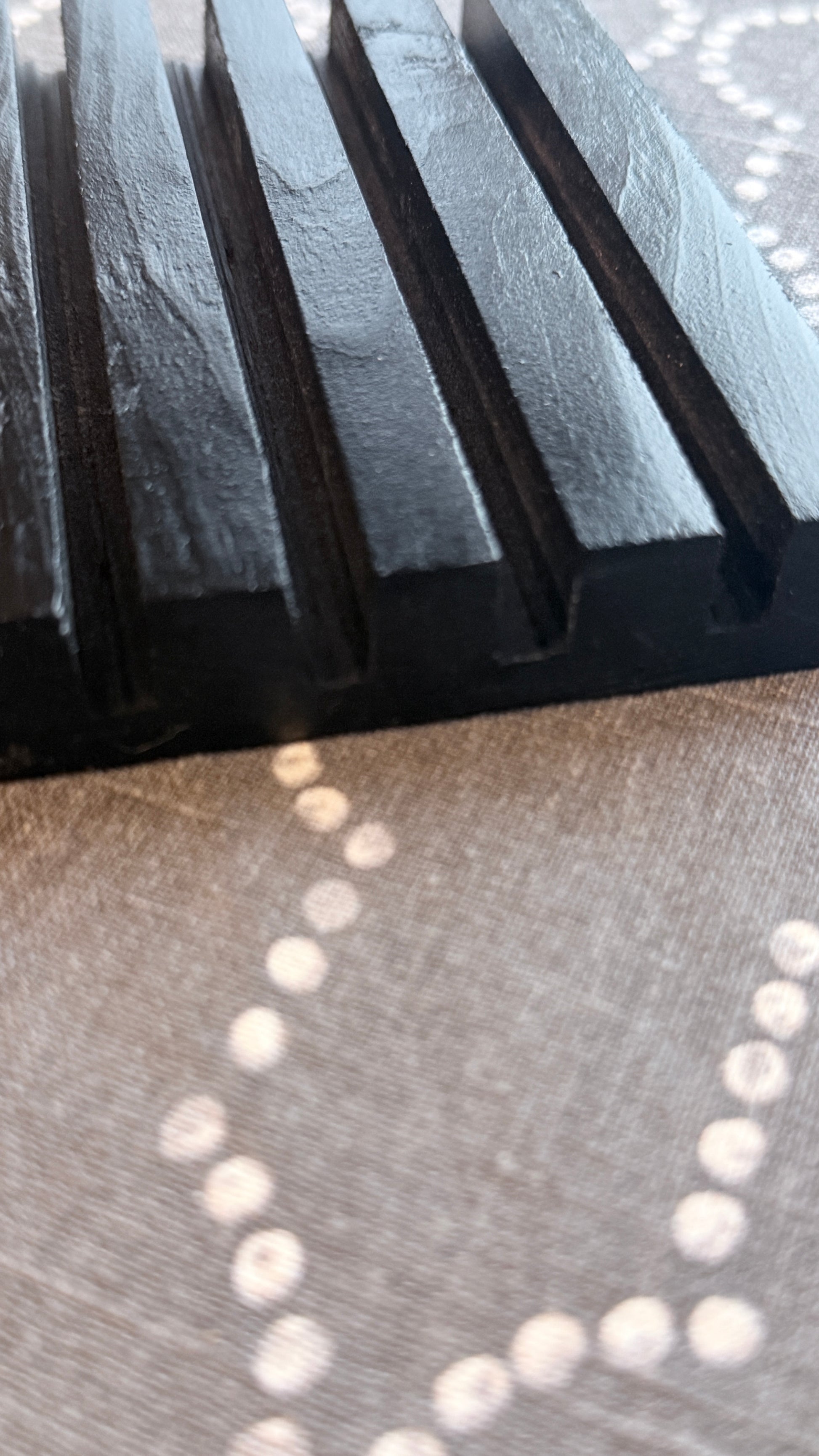 Close up side view of black stand 