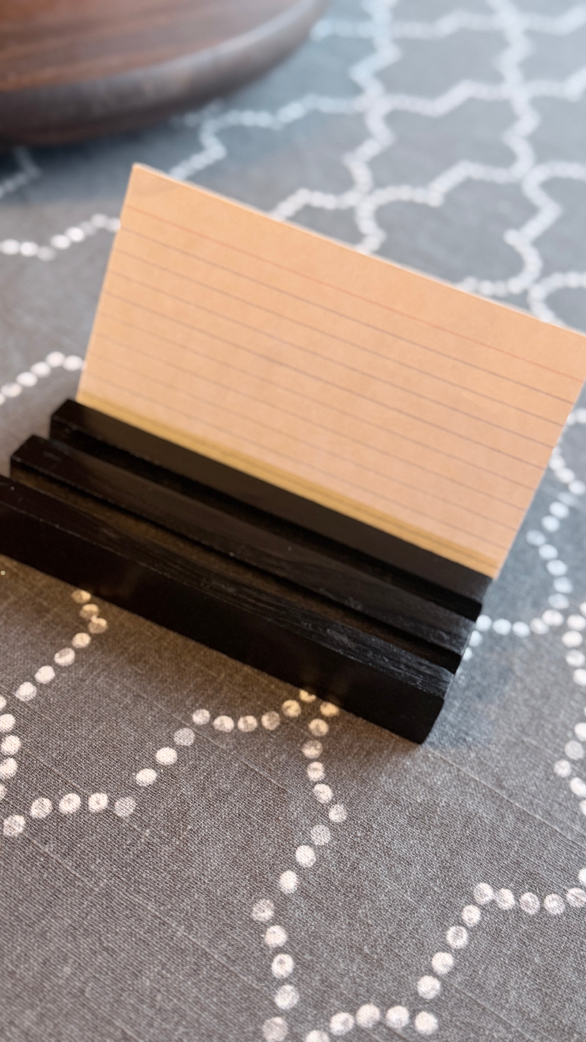 Black display stand with recipe card in one slot. 