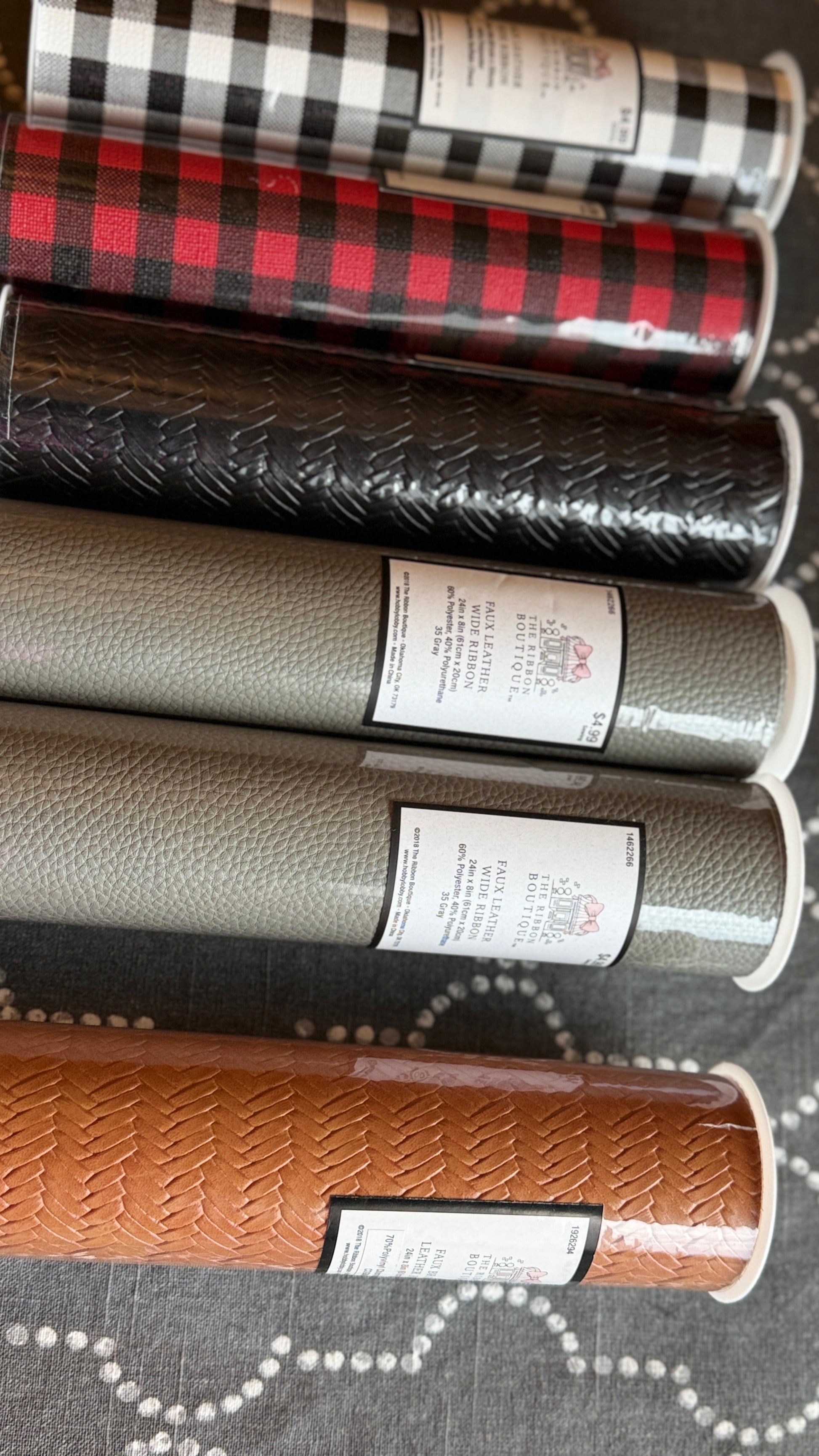 Six rolls of faux leather wide ribbon in assorted colors for Cricut crafts