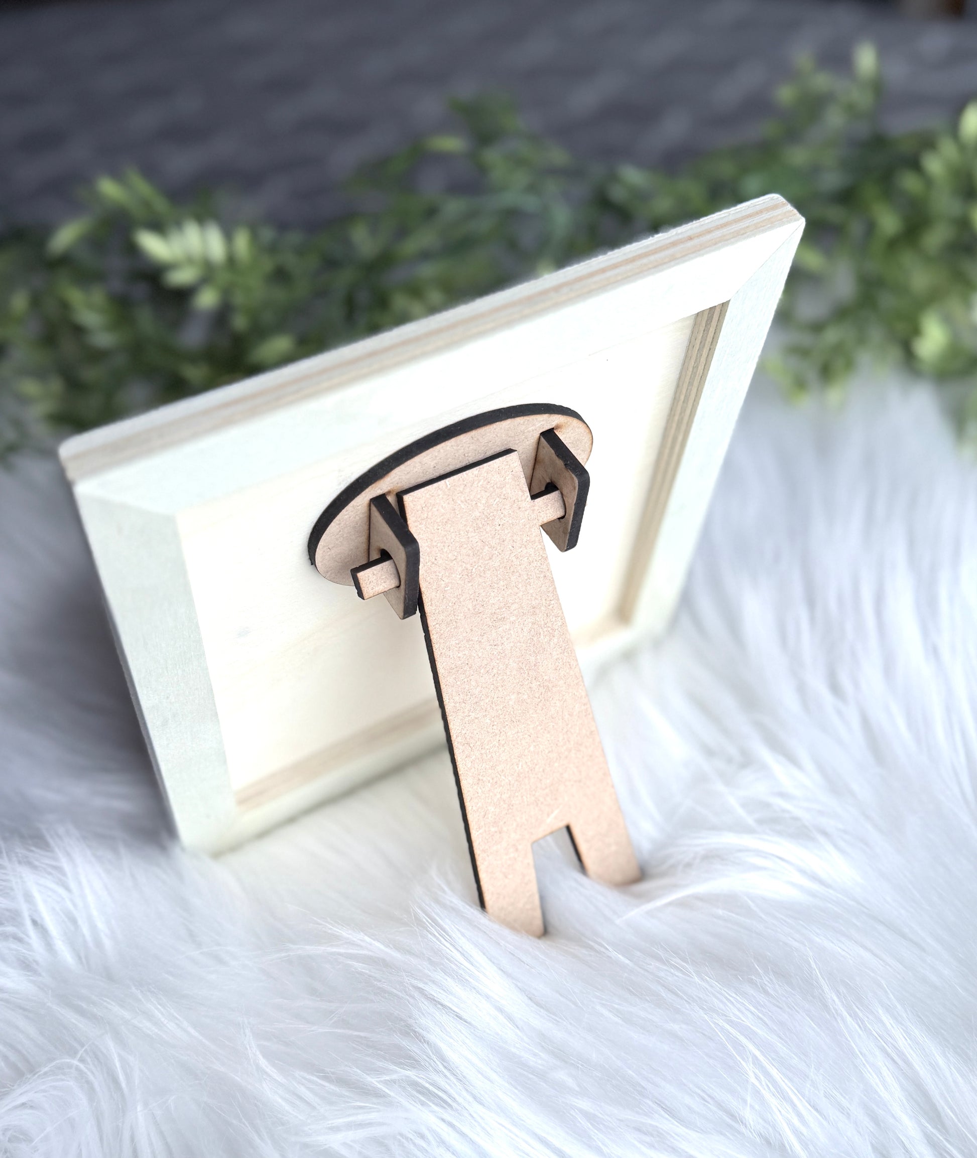 "Back view of Bee Kind wooden sign showing attached easel stand for freestanding display"