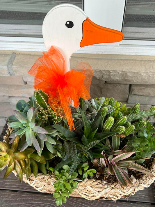 Decorative Goose plant stake with orange bow around the neck. 