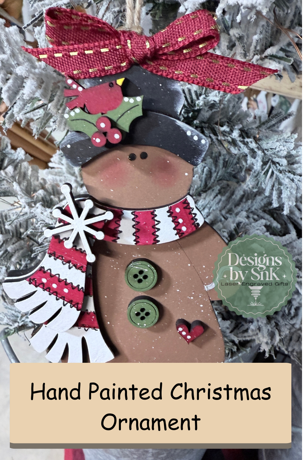 Decorative gingerbread man ornament with a red bow on a Christmas tree.