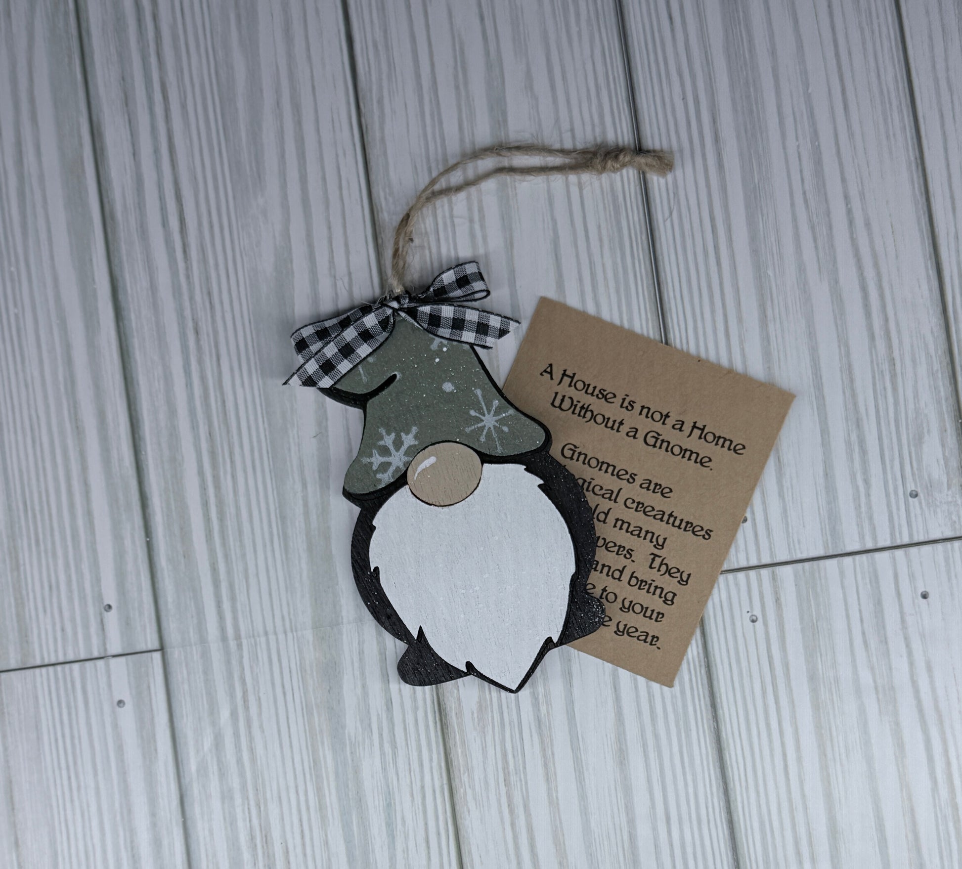 Decorative gnome with a tag on a wooden surface