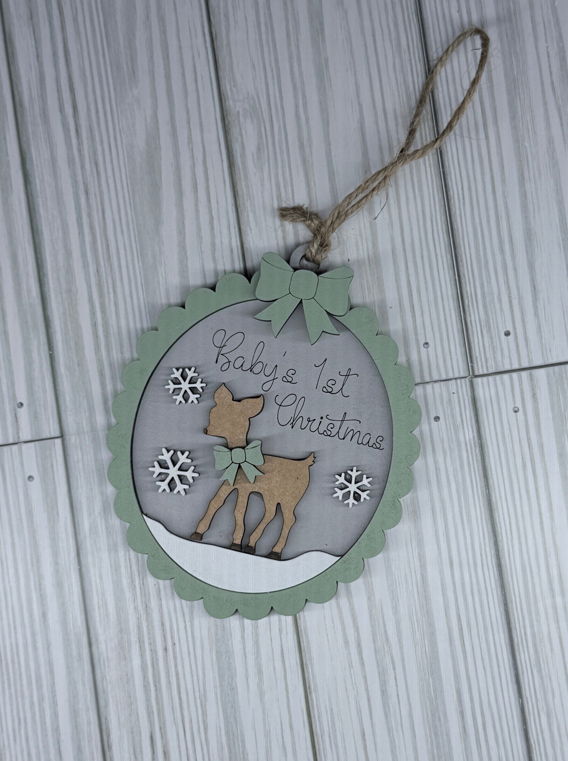 Decorative Christmas tag with a deer design on a wooden surface