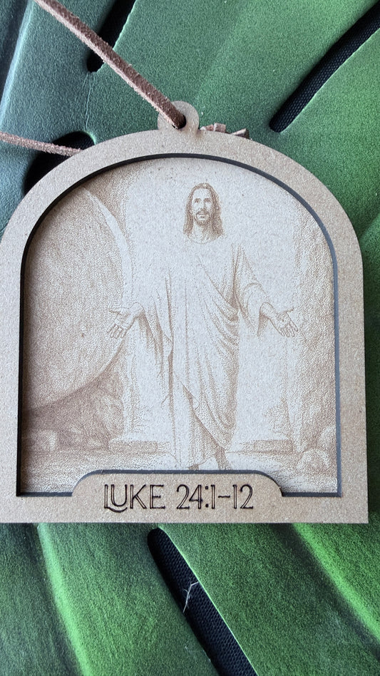 Close-up of Jesus Has Risen ornament showing layered design and hand-engraved Bible verse detail, Christian resurrection decoration with laminated verse card