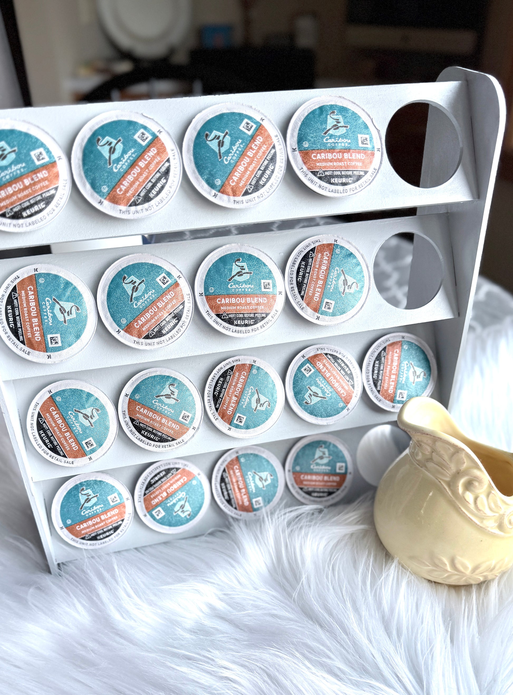K-Cup holder stand in use with coffee pods and creamer - practical coffee station setup