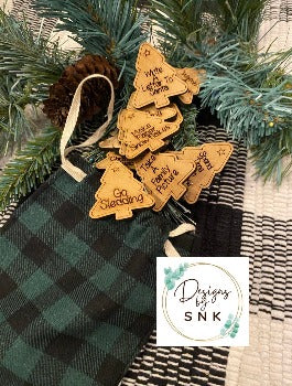 a bag with Winter Activities personalized tags on it next to a pine branch