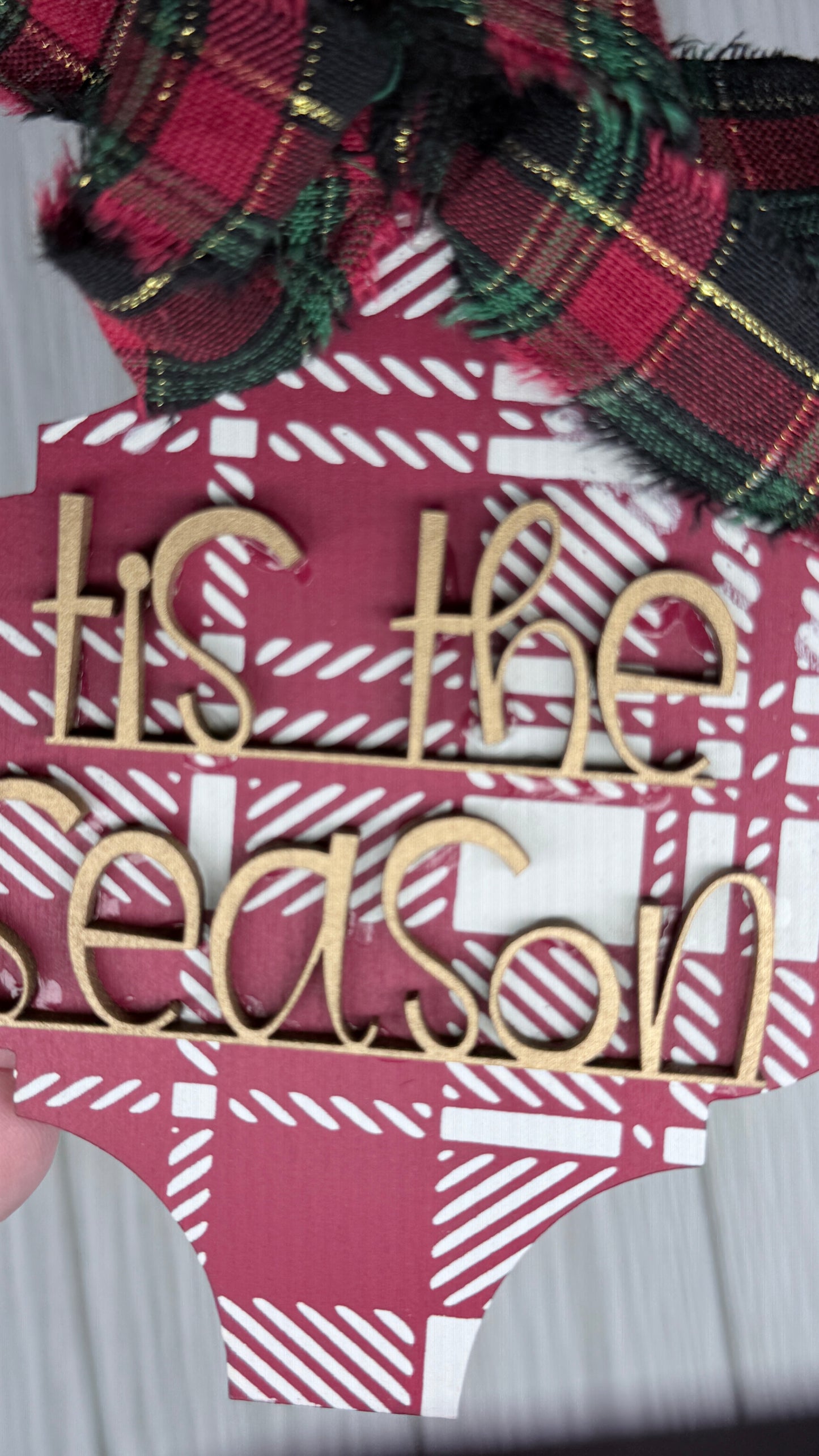 Red & Ivory plaid background ornament in with gold 3D letters that read, "Tis the Season" and fabric bow. 