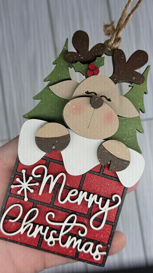 Wooden Christmas ornament with reindeer design and 'Merry Christmas' text.