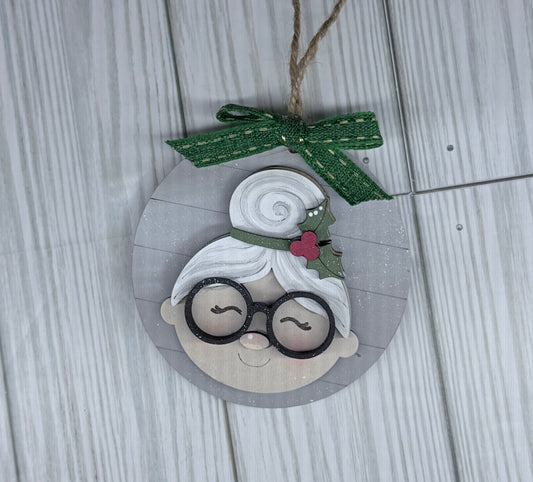 Round ornament features Mrs, Claus