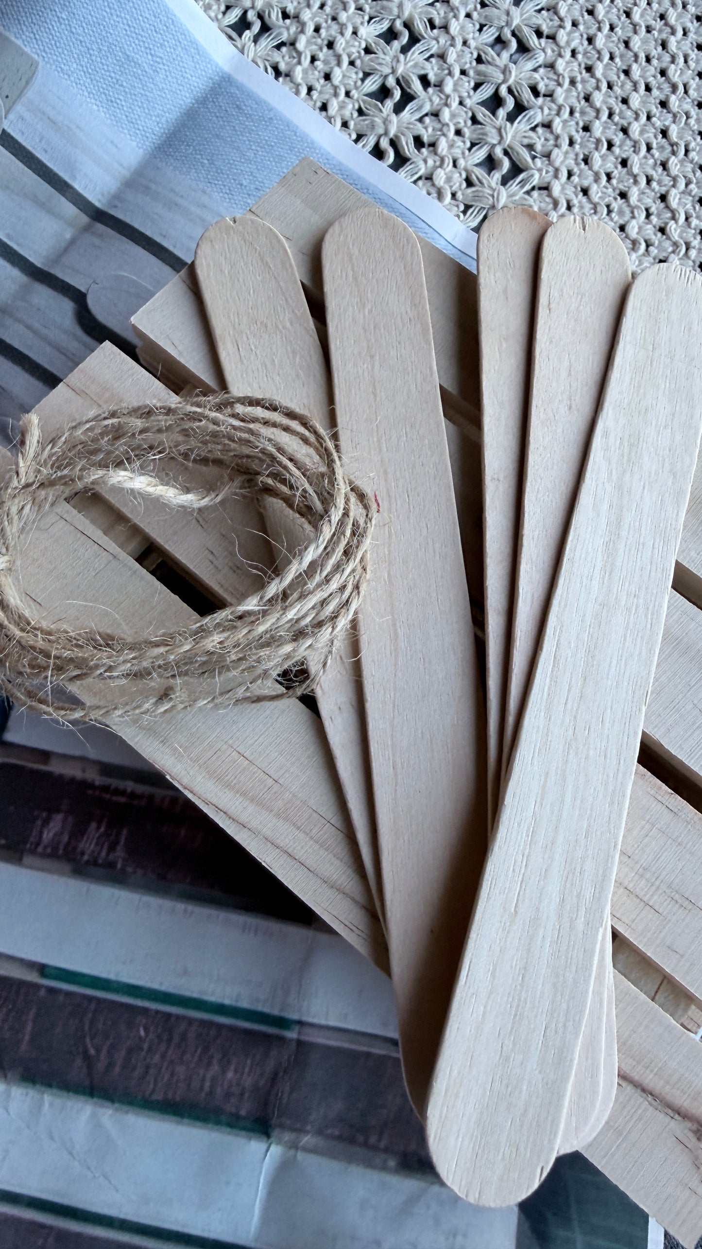 Wooden popsicle sticks on a textured surface with twine. used in the Americana flag kit 