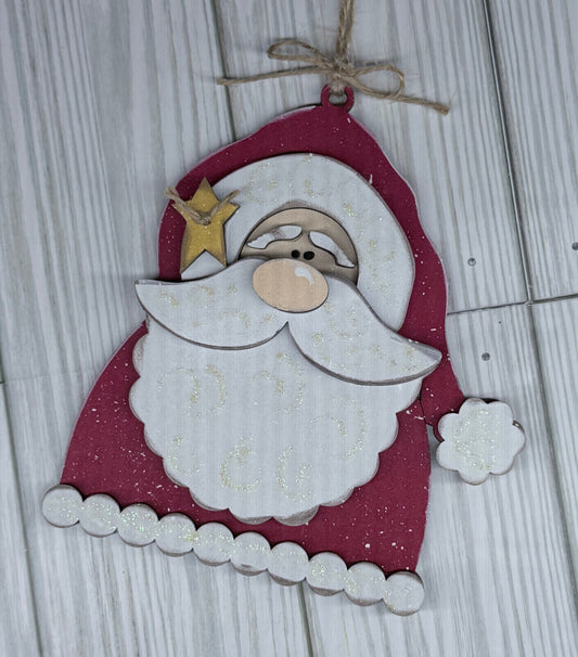 Decorative Santa Claus ornament hanging on a wooden surface